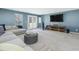 A carpeted living room features a large sectional sofa, TV, and natural light at 215 Brier Summit Pl, Durham, NC 27703