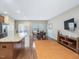 Bright living area showcasing hardwood floors leading to dining area at 215 Brier Summit Pl, Durham, NC 27703