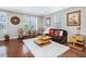 An open living room features hardwood floors, artwork, and natural light at 215 Brier Summit Pl, Durham, NC 27703