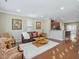 Open living room features hardwood floors, artwork, and seamless flow to the kitchen at 215 Brier Summit Pl, Durham, NC 27703