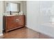 Cozy living room featuring a modern cabinet, elegant mirror, and light-filled window at 215 Brier Summit Pl, Durham, NC 27703