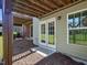 Exterior shot of a concrete patio in the backyard with double glass doors at 215 Brier Summit Pl, Durham, NC 27703