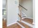 The home's wood staircase features white risers and neutral-toned walls at 215 Brier Summit Pl, Durham, NC 27703