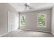 Bright bedroom featuring neutral walls, carpet, a ceiling fan, closet and two windows at 2208 Pathway Dr, Chapel Hill, NC 27516