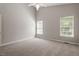 Spacious bedroom featuring neutral walls, carpet, a ceiling fan and two windows at 2208 Pathway Dr, Chapel Hill, NC 27516