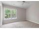 Bright bedroom featuring neutral walls, carpet, and a large window at 2208 Pathway Dr, Chapel Hill, NC 27516