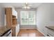 Kitchen breakfast nook features a window, wood floors, and built in desk and cabinets at 2208 Pathway Dr, Chapel Hill, NC 27516