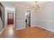 Bright dining room features modern light fixture, hardwood floors, and access to the kitchen at 2208 Pathway Dr, Chapel Hill, NC 27516