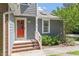 A welcoming entrance with a bright red door and brick steps leading to the front porch at 2208 Pathway Dr, Chapel Hill, NC 27516
