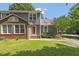 Charming home featuring a blend of brick and gray siding, and a well-manicured lawn at 2208 Pathway Dr, Chapel Hill, NC 27516