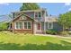 Charming two-story home with a well-manicured lawn, brick accent and inviting red front door at 2208 Pathway Dr, Chapel Hill, NC 27516