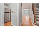 Hallway with hardwood floors, staircase, and access to a bright living space at 2208 Pathway Dr, Chapel Hill, NC 27516