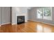Living room featuring a fireplace, large windows, and hardwood floors at 2208 Pathway Dr, Chapel Hill, NC 27516