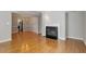 Living room featuring hardwood floors, fireplace, and open layout to the kitchen at 2208 Pathway Dr, Chapel Hill, NC 27516