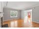 Living room with large windows, hardwood floors, and a view of the front yard at 2208 Pathway Dr, Chapel Hill, NC 27516