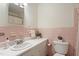 Bright bathroom featuring pink tiling and ample counter space at 2406 Oxford Rd, Raleigh, NC 27608