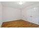 Bright bedroom with hardwood floors and a double door closet at 2406 Oxford Rd, Raleigh, NC 27608