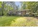 Brick home with lush green lawn offering a glimpse of a comfortable and well-maintained living space at 2406 Oxford Rd, Raleigh, NC 27608