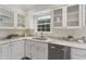 Beautiful kitchen featuring granite countertops, stainless steel appliances, and plenty of storage within the glass cabinets at 2406 Oxford Rd, Raleigh, NC 27608