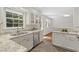 Well-lit kitchen with granite countertops, stainless steel appliances, and ample cabinet space for easy organization at 2406 Oxford Rd, Raleigh, NC 27608