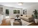 Cozy living room with hardwood floors, a comfortable sofa, and a view to the kitchen at 2406 Oxford Rd, Raleigh, NC 27608
