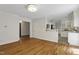 Open living room with hardwood floors flowing into an open floorplan featuring a bright kitchen at 2406 Oxford Rd, Raleigh, NC 27608