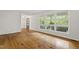Bright living room with hardwood floors, large windows overlooking trees, and offering an inviting, open atmosphere at 2406 Oxford Rd, Raleigh, NC 27608