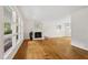 Spacious living room with a fireplace, hardwood floors, and large windows that flood the space with natural light at 2406 Oxford Rd, Raleigh, NC 27608