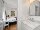 Bathroom features a marble countertop sink, and an open doorway to a bedroom at 2410 Huron St, Durham, NC 27707