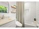 Bright bathroom features subway tile in the tub/shower, stylish shelves, and a modern toilet at 2410 Huron St, Durham, NC 27707