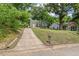 Charming home with a long driveway and well-maintained lawn on a sunny day at 2410 Huron St, Durham, NC 27707