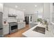 Bright kitchen with white cabinets, stainless steel appliances and a large sink under a window at 2410 Huron St, Durham, NC 27707