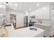 Clean kitchen with white cabinets, quartz countertops, stainless steel appliances, and hardwood floors at 2410 Huron St, Durham, NC 27707