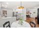 Bright kitchen featuring white cabinets, stainless steel appliances, and a marble-topped dining table at 2410 Huron St, Durham, NC 27707