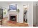Living room featuring a brick fireplace, hardwood floors and a peek into the closet at 2410 Huron St, Durham, NC 27707