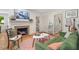 Bright living room featuring hardwood floors, fireplace, and a green sofa at 2410 Huron St, Durham, NC 27707