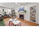 Living room featuring hardwood floors, fireplace, stylish furniture and view to outside at 2410 Huron St, Durham, NC 27707