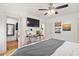 Bright main bedroom offers hardwood floors, a ceiling fan, walk-in closet, and workspace at 2410 Huron St, Durham, NC 27707
