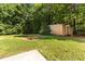 Grassy backyard featuring storage shed and mature trees at 2555 Winding Creek Ln, Franklinton, NC 27525