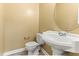 Well-lit half bathroom featuring a classic pedestal sink and tile floors at 2555 Winding Creek Ln, Franklinton, NC 27525