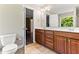 Bathroom with double vanity, wood cabinets, and tiled floor at 2555 Winding Creek Ln, Franklinton, NC 27525