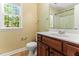 Bright bathroom featuring a wood vanity and a large window for natural light at 2555 Winding Creek Ln, Franklinton, NC 27525
