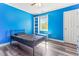 Bright bedroom with blue walls, wood-look floors, built-in shelves and window at 2555 Winding Creek Ln, Franklinton, NC 27525