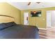 Bedroom features wood-look floors, ensuite closet, and mounted TV at 2555 Winding Creek Ln, Franklinton, NC 27525