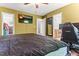 Bedroom featuring wood-look floors, TV, multiple closets, and ensuite bathroom at 2555 Winding Creek Ln, Franklinton, NC 27525