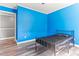 Bedroom features bright blue walls, wood-look floors and a walk-in closet at 2555 Winding Creek Ln, Franklinton, NC 27525