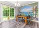 Elegant dining area with stylish mural accent wall, modern table set and sliding door access at 2555 Winding Creek Ln, Franklinton, NC 27525