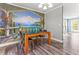 Elegant dining area with stylish mural accent wall, modern table set and sliding door access at 2555 Winding Creek Ln, Franklinton, NC 27525