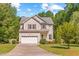 Charming two-story home featuring a well-maintained lawn and an attached two-car garage at 2555 Winding Creek Ln, Franklinton, NC 27525