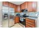 Well-lit kitchen featuring stainless steel appliances, tile backsplash, and ample cabinet space at 2555 Winding Creek Ln, Franklinton, NC 27525